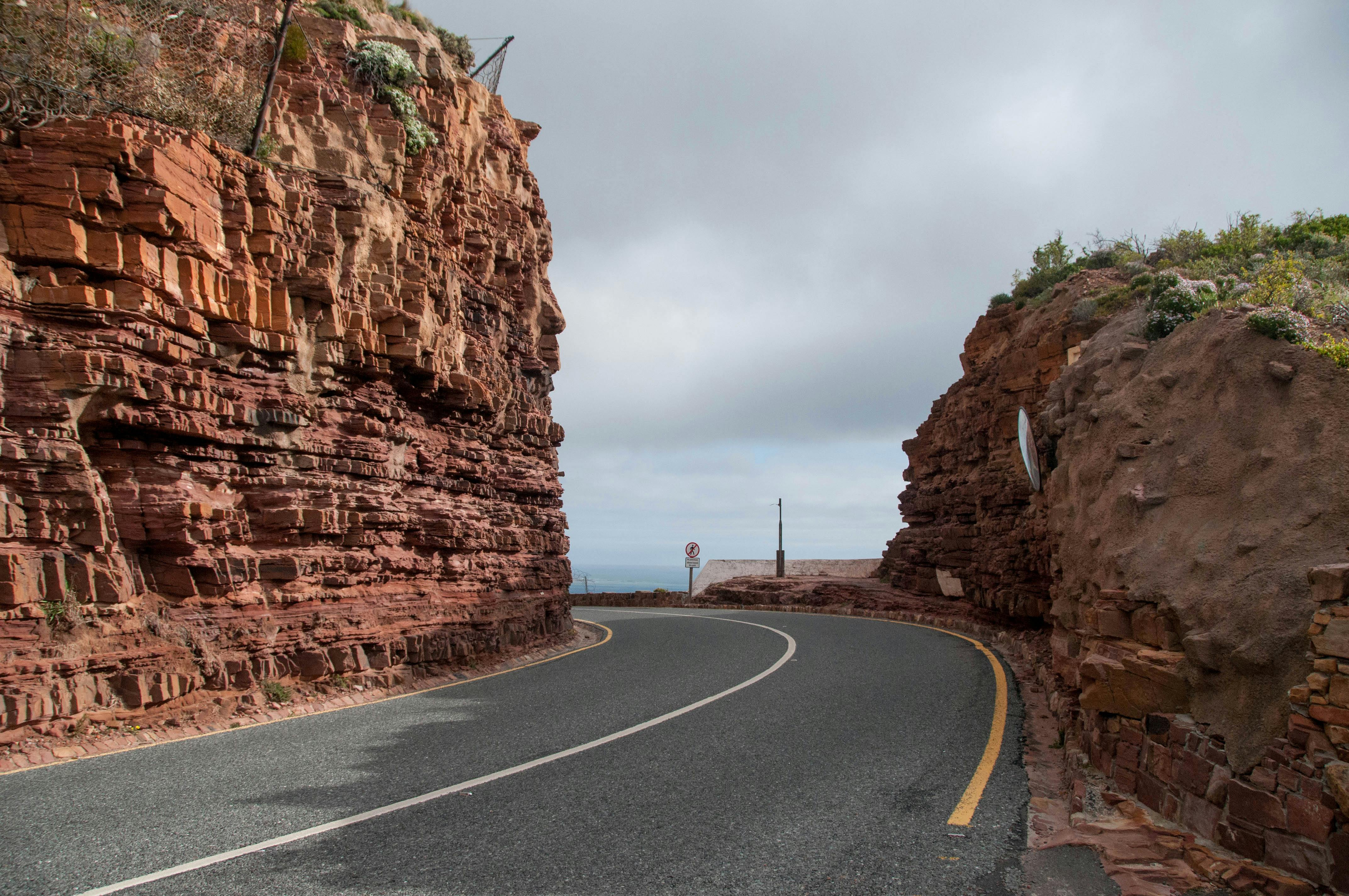 Winding coastal road carved into the cliff along Chapman's Peak Drive