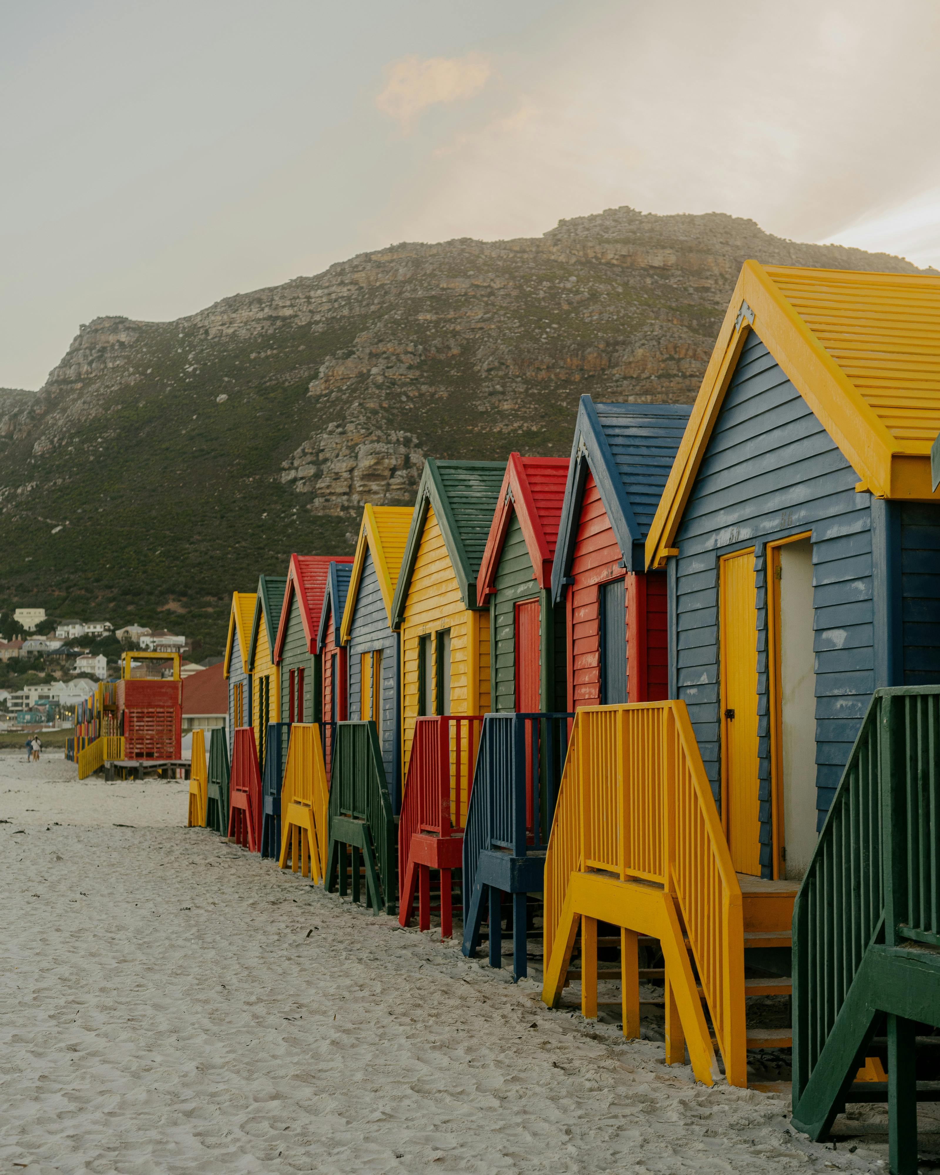 Row of brightly painted beach huts along Muizenberg Beach